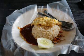 Close up of Nasi lemak, a Malay style complete meal of fragrant rice cooked in coconut milk.