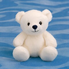 A cute, soft, white teddy bear sitting on a blue background.