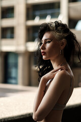 Pensive young woman looking away in urban environment.