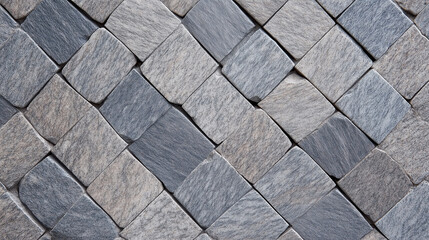 A captivating mosaic pattern composed of various gray and white stones arranged in a geometric diamond shape. 