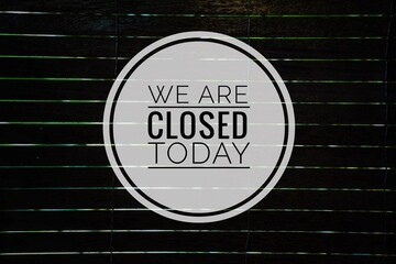 We Are Closed Today word concept on blurry dark background
