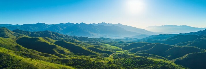 Fototapeta premium An aerial view of a lush valley surrounded by majestic mountains, showcasing the beauty of nature, serenity, tranquility, and the vastness of the landscape.