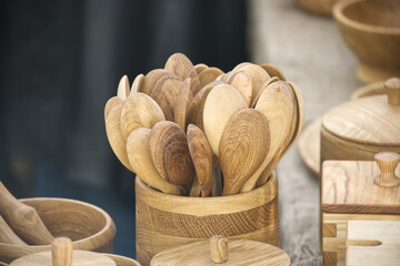 An assortment of handcrafted wooden spoons and bowls displayed at a market