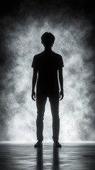 Obraz premium Silhouette of a person standing against a smoky background.
