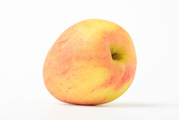 Fresh ripe apple with tiny water drops on white background