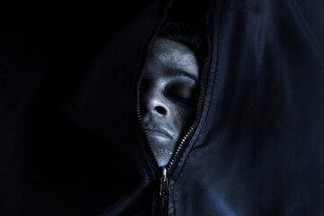 Closeup of dead man inside open corpse body bag, Halloween theme