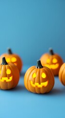 Glowing jack-o'-lanterns set against a blue background, creating a festive Halloween vibe.