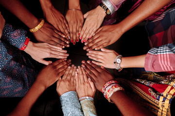 Hands of a group of multinational people which stay together in circle