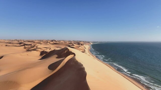 Aerial drone view of the Namib dunes close to the ocean shore beaches on a beautiful day of adventure at sunset, Namibia, Africa