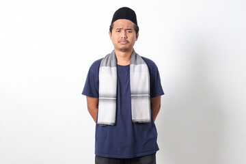 Portrait of unhappy Asian muslim man wearing sarung scarf feeling depressed and disappointed. Isolated image on white background