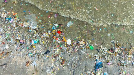 Trash, plastic cups and plastic bags at the beach. environmental problem concept and healing the...