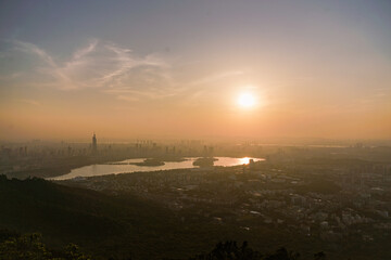 sunset over the foggy city
