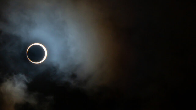 Solar Eclipse in the clouds over Easter Island in a Ring of fire with baileys beads visible in the annular solar eclipse