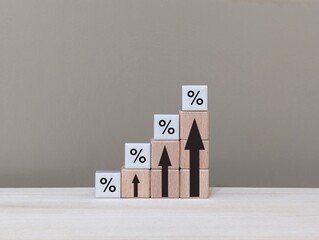 wooden cube with up arrow sign and percent symbol. the concept of mortgage rates, and interest rates.