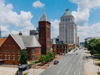 Downtown buildings and West Market Street United Methodist Church, Greensboro, North Carolina,...