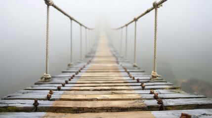 Obraz premium Misty Pathway on a Suspended Wooden Bridge