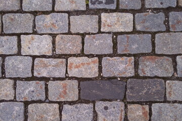 Paving stones. Rough background of masonry. Uneven brick surface
