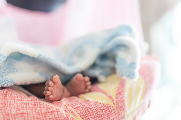 ndian family spending time together, wearing traditional and casual outfits with a baby, a young girl, and grandparents in a high-rise apartment in Kuala Lumpur, Malaysia.