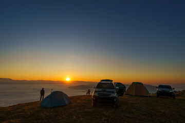 Beautiful scenery of the sea of mist in the morning at the Car Camping site with viewpoint nature at Doi Ba Lu Kho Mountain View Point, Mae Chaem, Chiang Mai, Northern Thailand. Background concept.