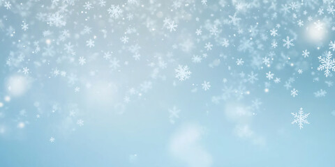Fototapeta premium Delicate snowflakes gently falling against a soft blue gradient background, evoking the peaceful beauty and serenity of winter