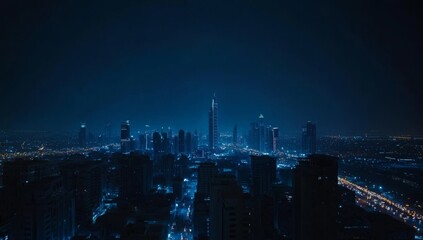 Fototapeta premium A panoramic night view of a cityscape with skyscrapers and street lights.