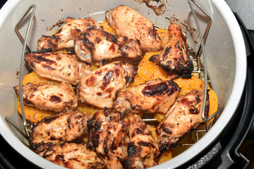Top view of cooked chicken meat in a slow cooker.