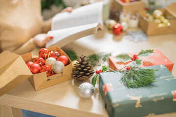 Happy woman  reading book celebrating christmas at home relax Xmas holiday