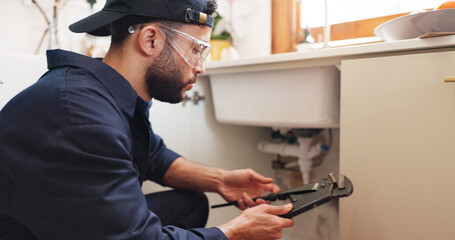 Plumber, house or handyman with wrench for maintenance, skills or small business. Person, employee or repair with equipment, safety or industry with service, home renovation or labour with contractor