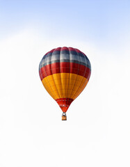 Fototapeta premium A colorful hot air balloon floats against a clear sky.