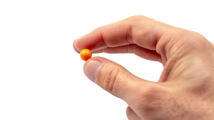 Photo of a Hand Holding a Vitamin Pill