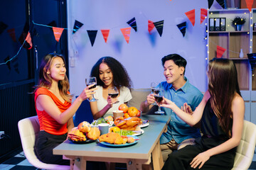 Friends celebrate indoors with food and wine, sharing laughs and toasts at a festive gathering.