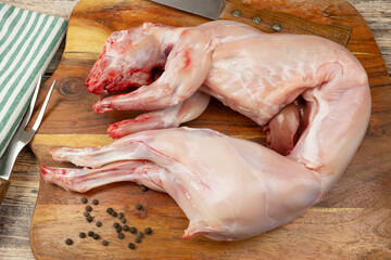 lapin entier, prêt à cuisiner, sur une planche à découper