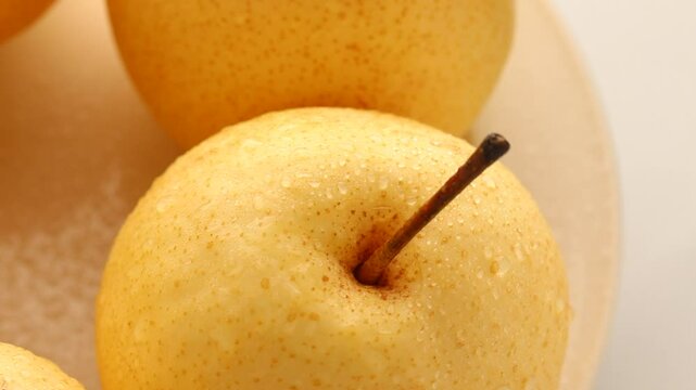 Top view of asian pears fruit with water drops rotating