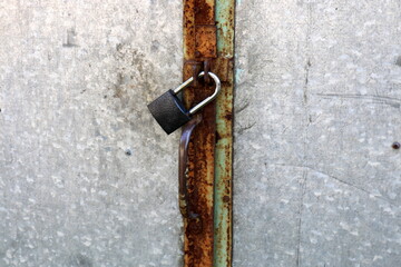 a metal padlock hangs on the closed doors