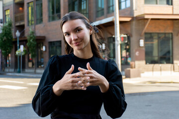 Sign Language Interpreter signs 'America' in ASL