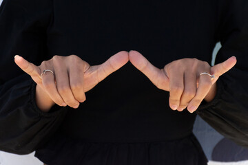 Closeup of hands signing 'same-as' in ASL