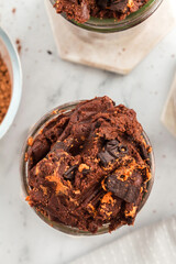 Overhead view of no-bake brownie batter with Halloween cookies