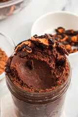 Non-bake brownie batter mixed with Halloween cookies in a jar