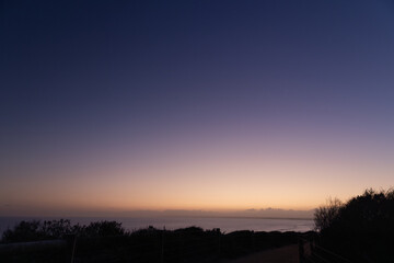 Fototapeta premium Twilight purple sunset over silhouette Coastal Horizon