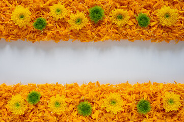 Decorative orange color marigold flower petals rangoli with Chrysanthemum flowers for Diwali festival with white space background.