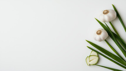 Obraz premium Fresh garlic cloves and green garlic leaves arranged beautifully on light background create vibrant and natural composition. This captures essence of healthy cooking and fresh ingredients