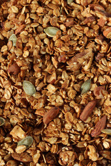 Oat Granola with Almonds, Walnuts, Sesame and Pumpkin Seeds, Closeup Full Frame Background. Cereals.