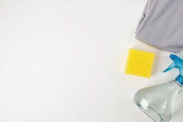 Effective cleaning concept with spray bottle, sponge, and towel for housekeeping and maintenance.