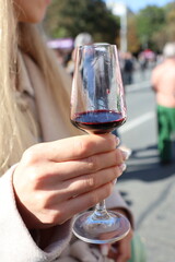 An Elegant Wine Glass Being Held Outdoors With Beautiful Reflection in the Surroundings