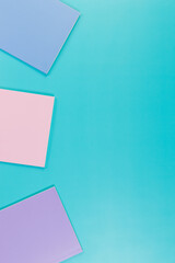 Top view of pink, purple and blue notebooks on blue background. Pink, yellow and blue pens, school, office wallpaper. Flat lay, copy space.