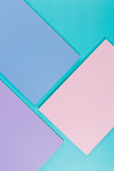 Top view of pink, purple and blue notebooks on blue background. Pink, yellow and blue pens, school, office wallpaper. Flat lay, copy space.