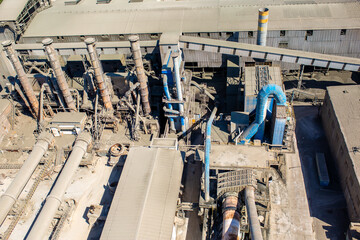 Cement plant view from above. Workshops and compressors, equipment, metallurgy. Technological work on cement production. Industrial production on a large scale.