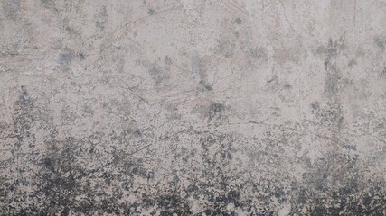 Obraz premium Close-up of a weathered concrete wall with cracks and imperfections.