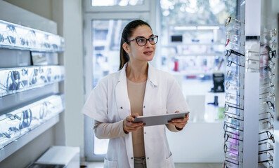 Optician at eyeglasses shop. Medical, health care concept
