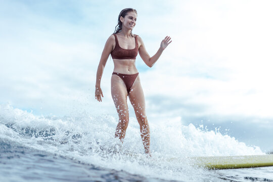 Close up of woman surfing a wave